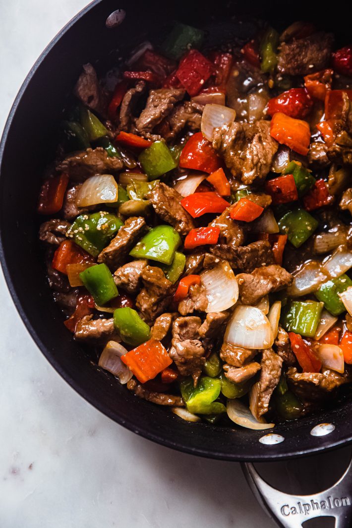 thinly sliced beef and peppers steak in pan
