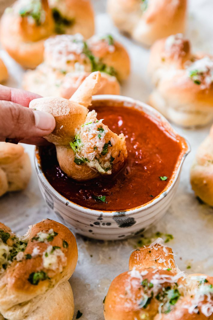 Dipping garlic knot in pizza sauce