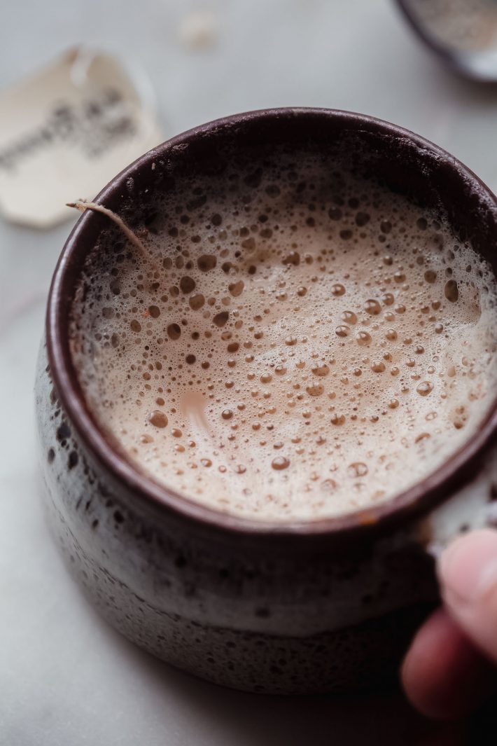 foamy milk on a latte in brown mug
