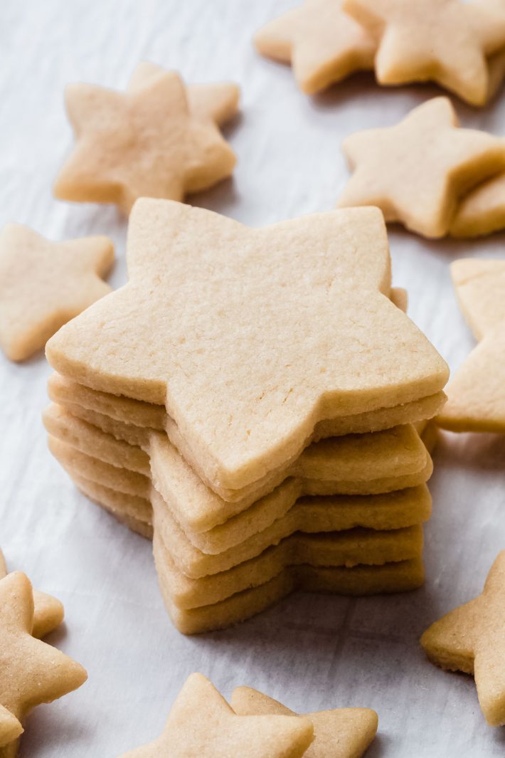 stack of star shaped cookies on white parchment
