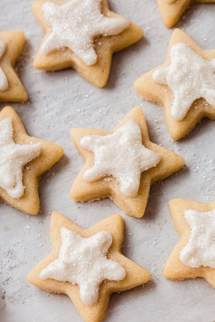 decorated star cut out sugar cookies on white parchment