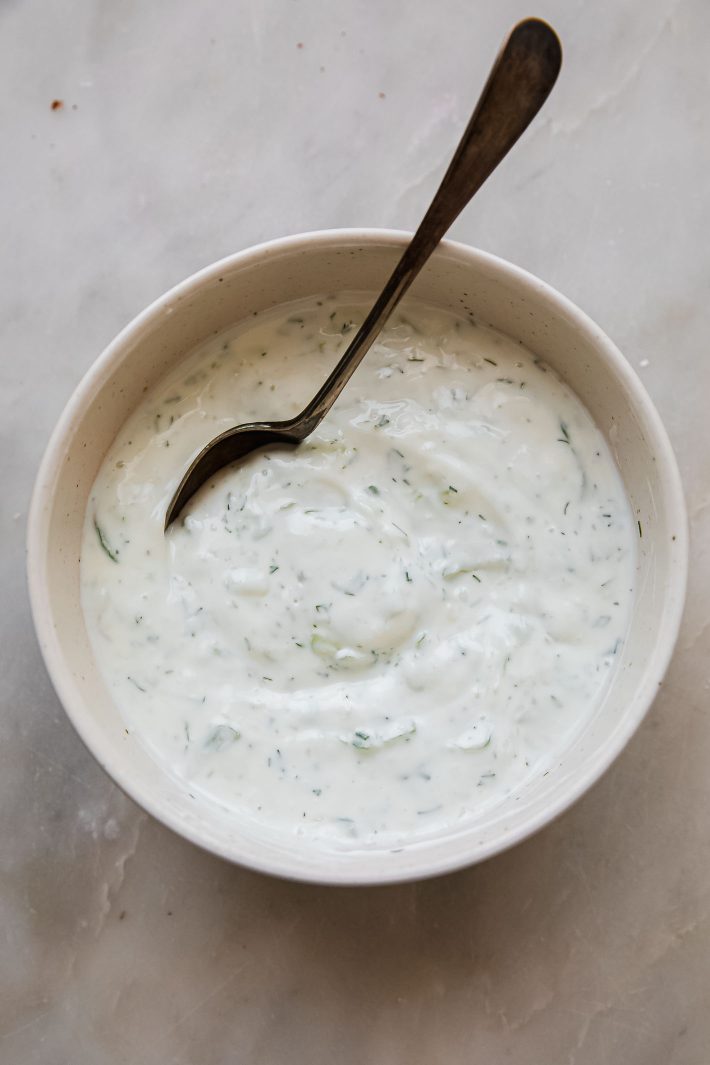 tzatziki sauce in bowl with spoon