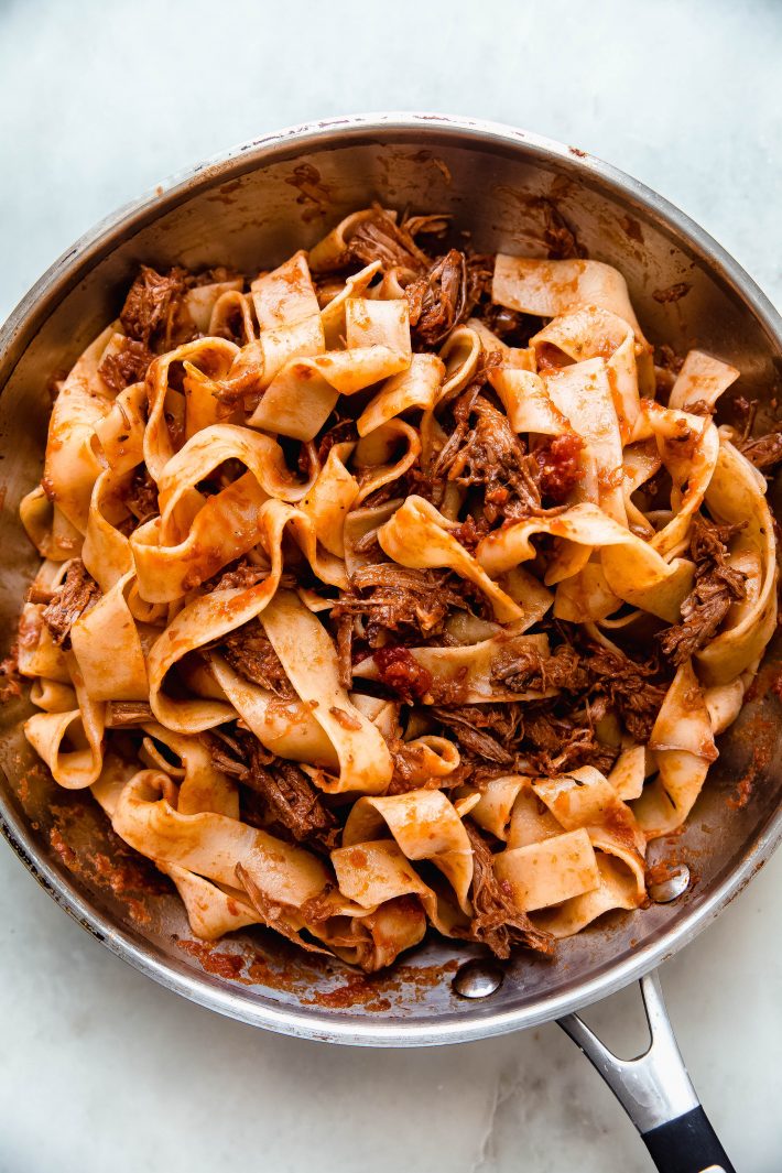 skillet with tossed ragu and pappardelle