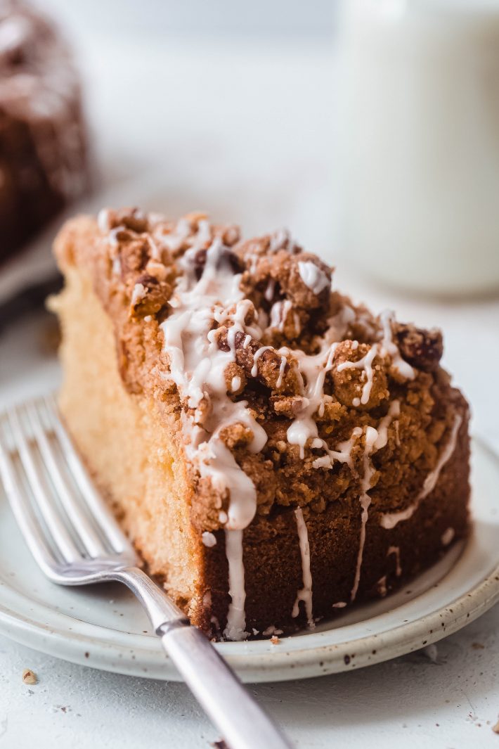 sliced coffee cake with icing on plate with fork