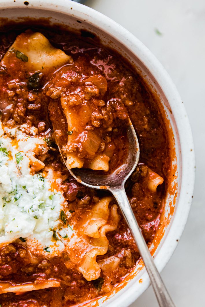 lasagna soup on spoon from bowl