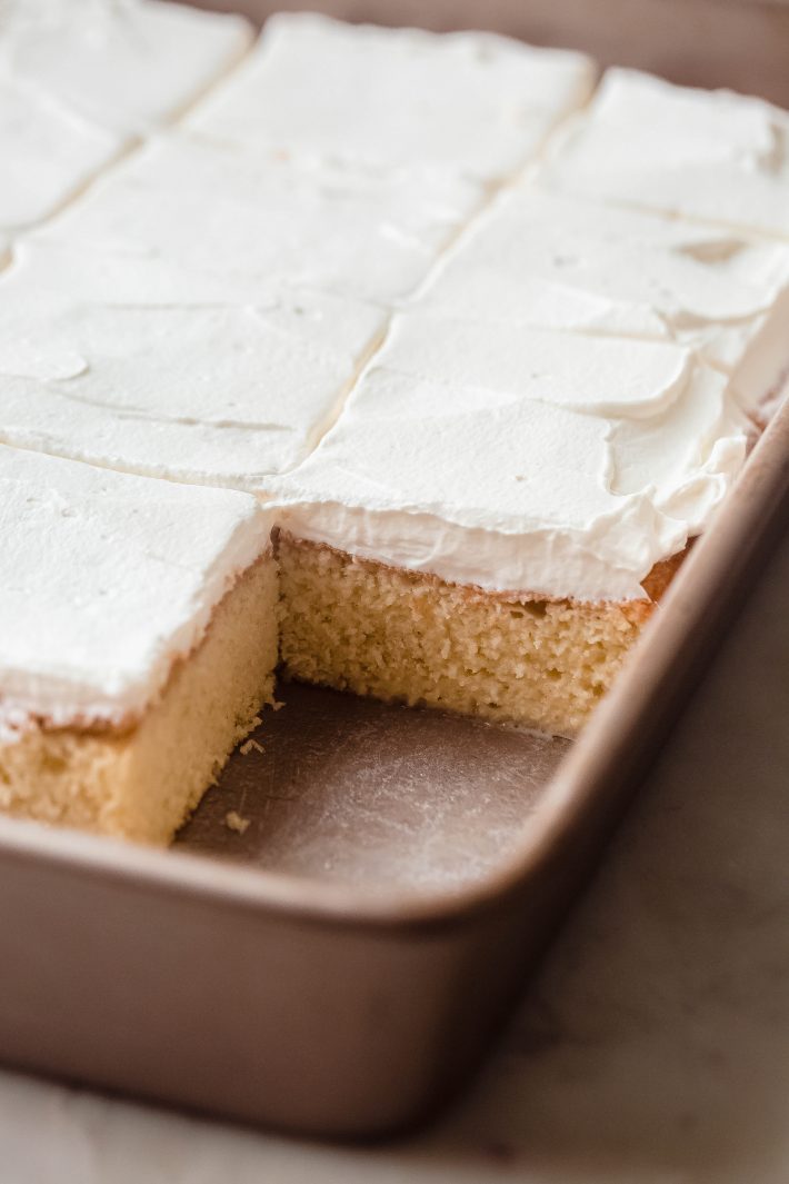 tres leches in baking pan with slice missing