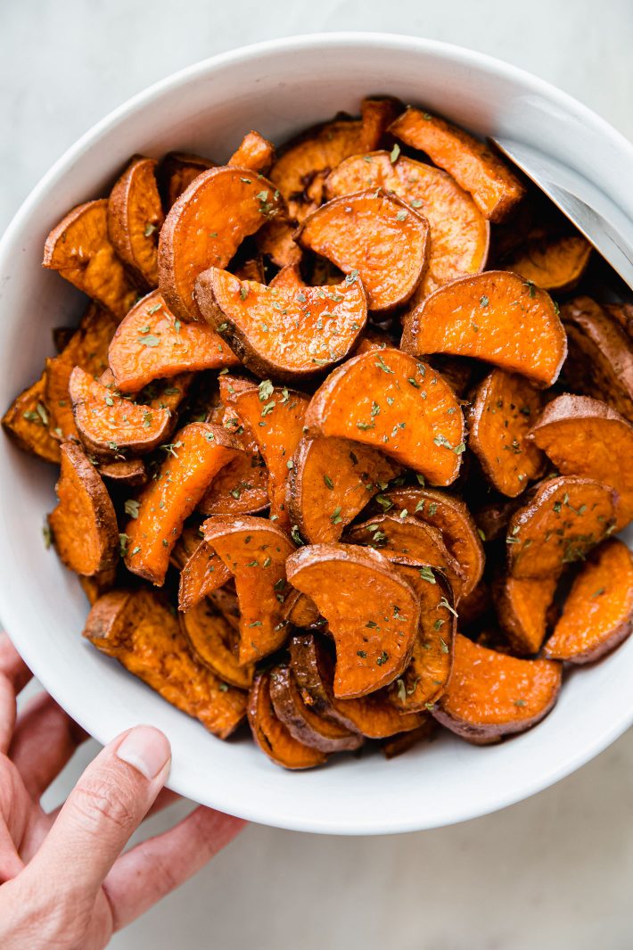 sweet potatoes in bowl with dried parsley